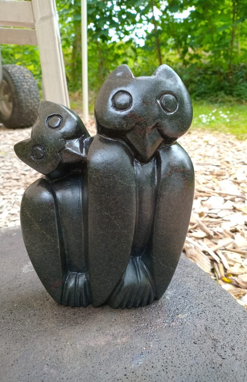 Whimsical Decorative Sculpture of Stylized Owls in Dark Stone